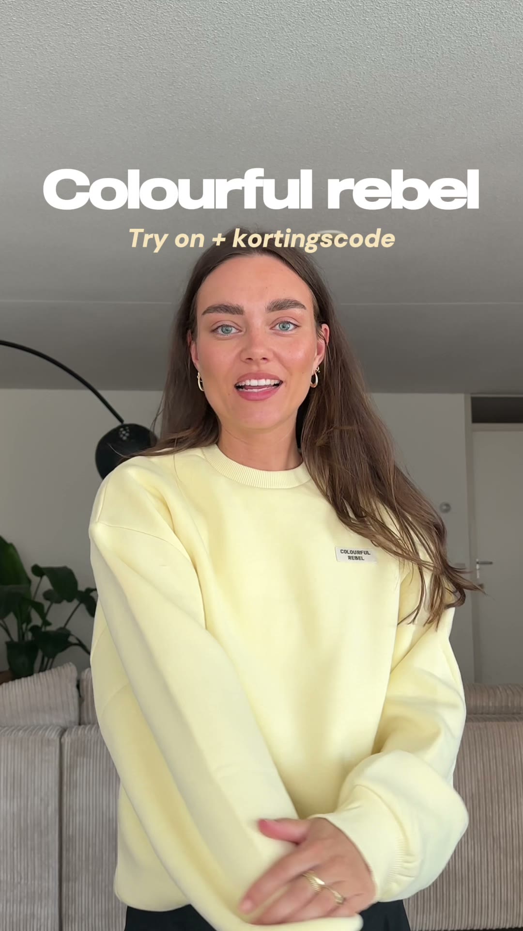 Sabine wearing a yellow Colourful Rebel sweater