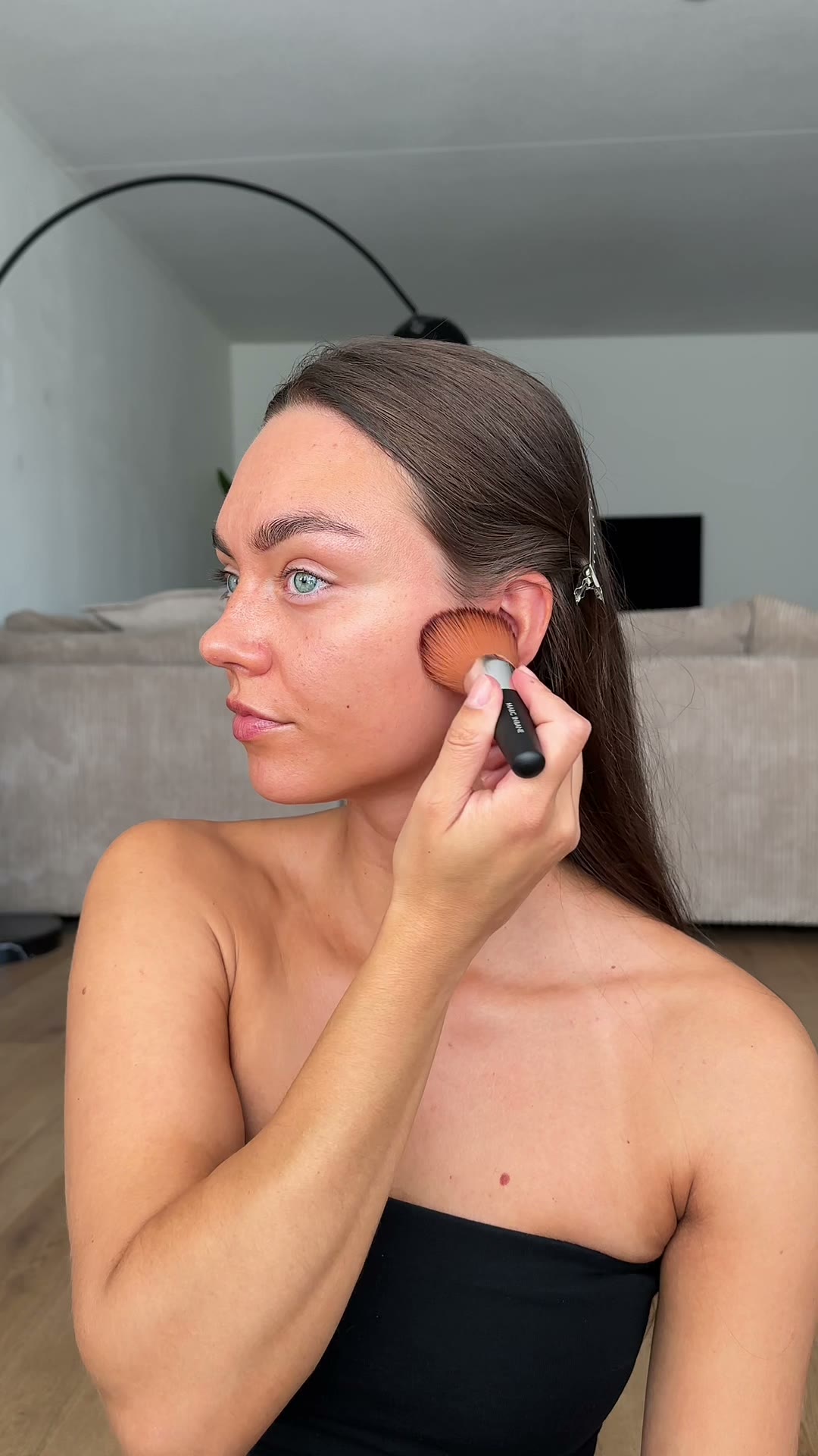 Sabine applying self tan with a brush