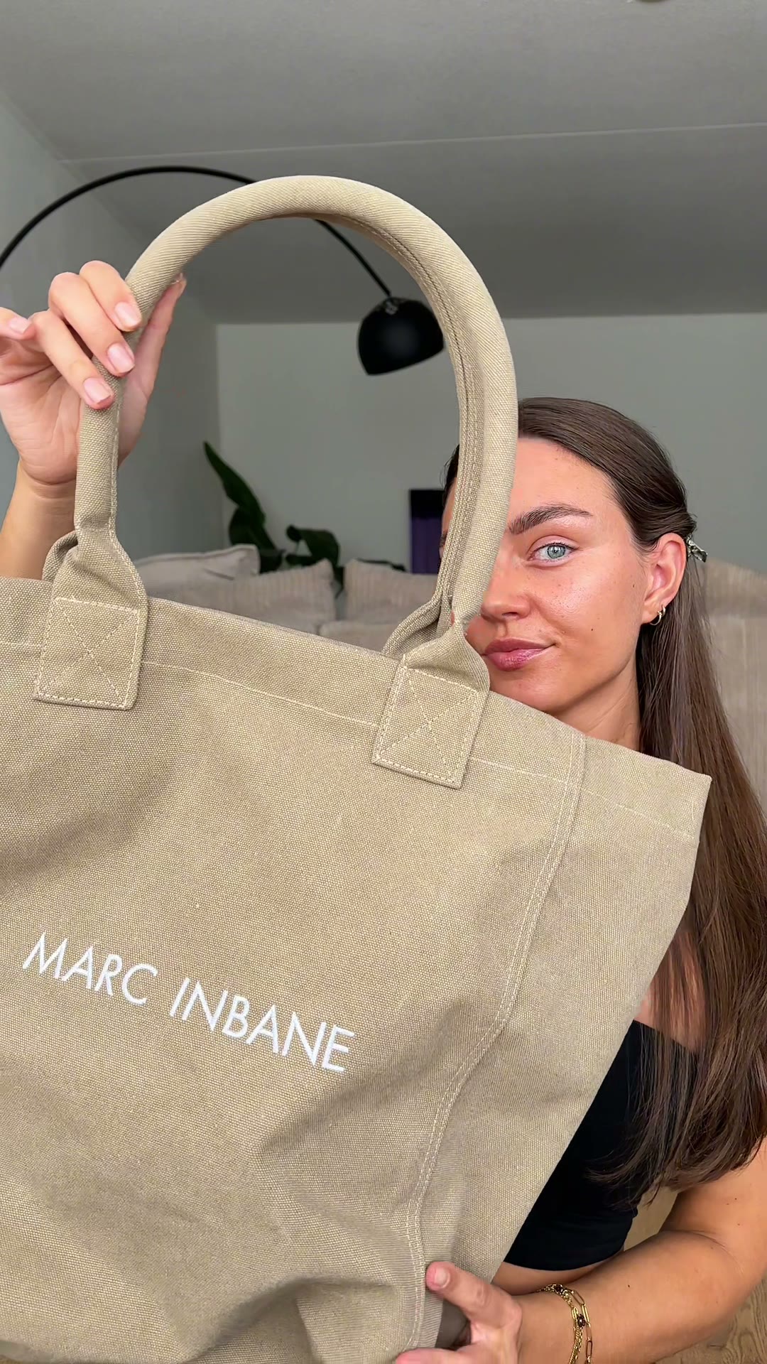 Sabine holding up a Marc Inbane bag