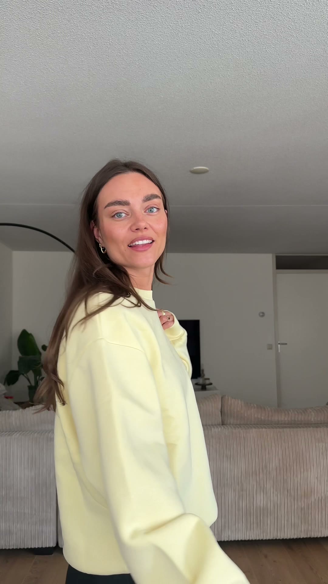 Sabine wearing a yellow sweater